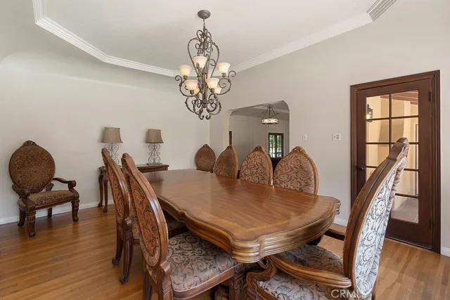 a view of a dining room with furniture wooden floor and chandelier