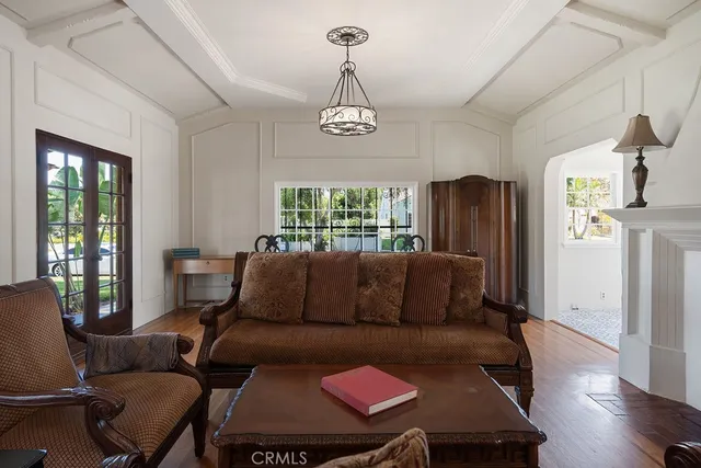 a living room with furniture wooden floor and a window