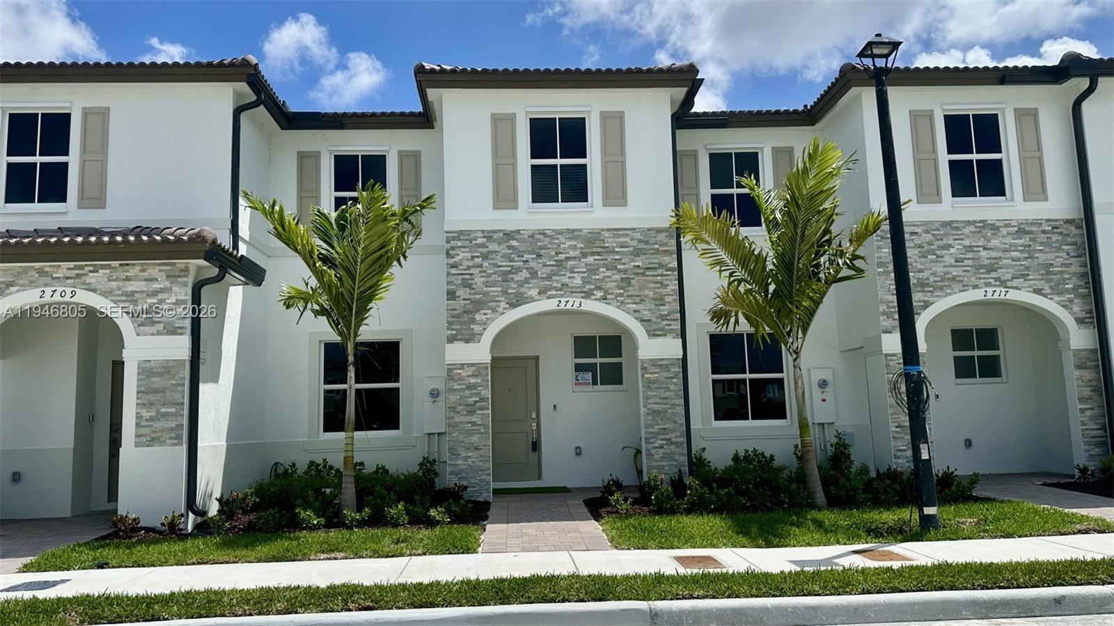2713 Southeast 26th Road Homestead, FL 33035 - Photo 1 of 27 a front view of a house with a garden