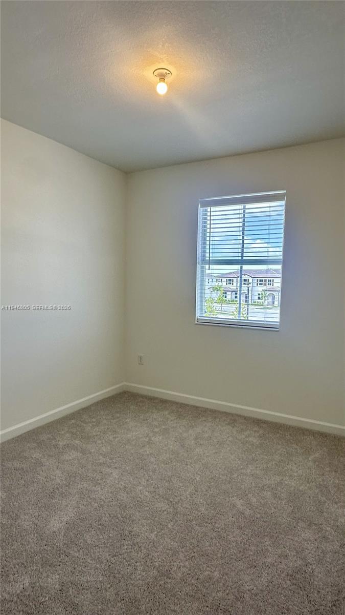 2713 Southeast 26th Road Homestead, FL 33035 - Photo 21 of 27 an empty room with a empty space and windows