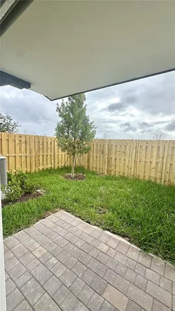 a view of a backyard with pathway