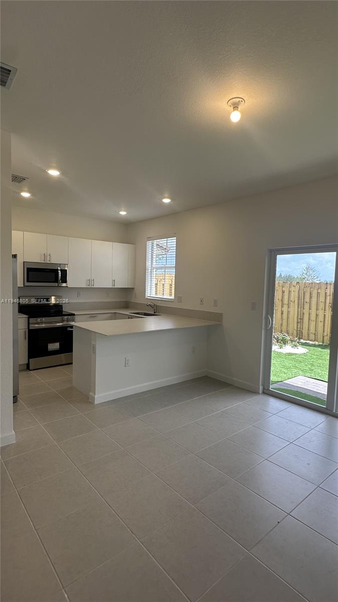 2713 Southeast 26th Road Homestead, FL 33035 - Photo 7 of 27 a view of a kitchen with a sink cabinets and a window