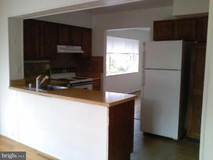 5403 Littleford Street Springfield, VA 22151 - Photo 2 of 21 a kitchen with a refrigerator and a sink