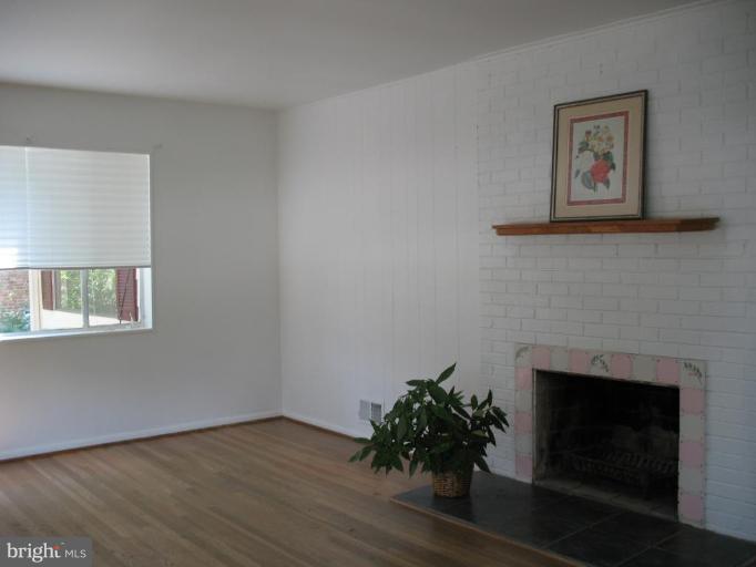 5403 Littleford Street Springfield, VA 22151 - Photo 18 of 21 a room with a fireplace and wooden floor