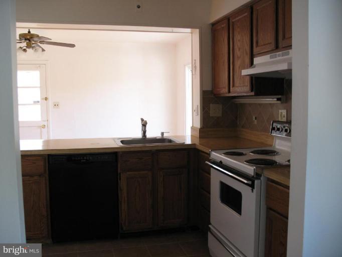 5403 Littleford Street Springfield, VA 22151 - Photo 3 of 21 a kitchen with stainless steel appliances a stove and a microwave