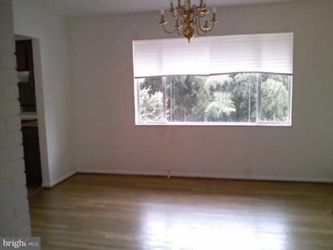 5403 Littleford Street Springfield, VA 22151 - Photo 4 of 21 an empty room with wooden floor and windows