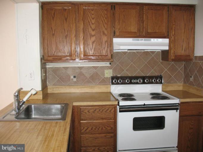 5403 Littleford Street Springfield, VA 22151 - Photo 9 of 21 a kitchen with granite countertop a stove and a sink