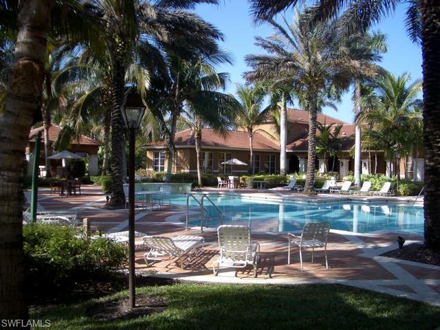 1210 Reserve Way, Unit 9203 Naples, FL 34105 - Photo 12 of 18 a front view of a house with garden and sitting area