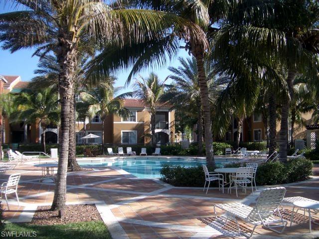 1210 Reserve Way, Unit 9203 Naples, FL 34105 - Photo 13 of 18 a view of a yard with plants and trees