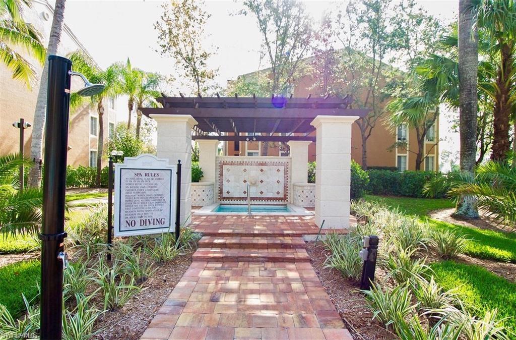 1210 Reserve Way, Unit 9203 Naples, FL 34105 - Photo 15 of 18 a front view of a house with garden