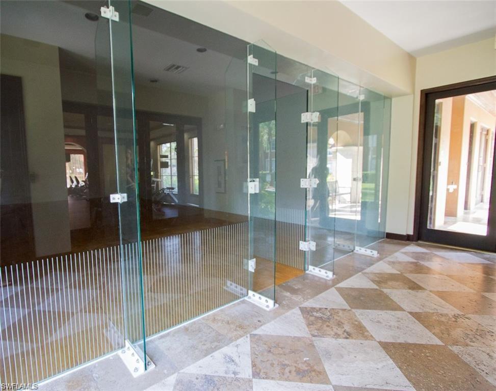 1210 Reserve Way, Unit 9203 Naples, FL 34105 - Photo 17 of 18 a bathroom with a glass shower door