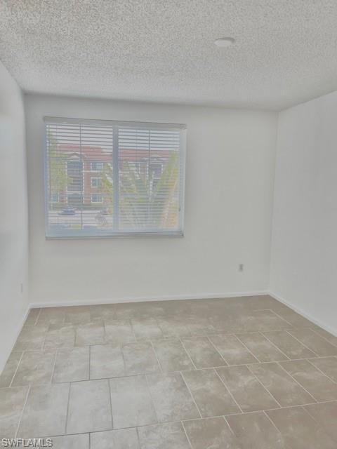 1210 Reserve Way, Unit 9203 Naples, FL 34105 - Photo 6 of 18 an empty room with a window
