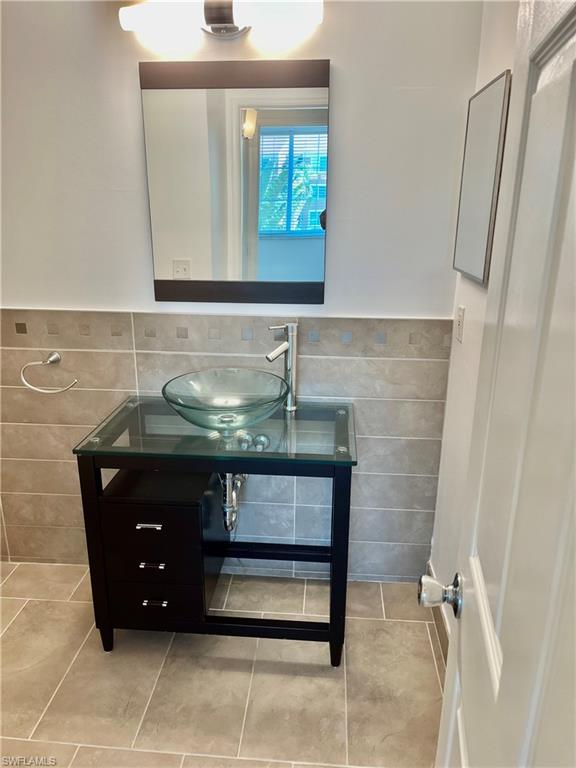1210 Reserve Way, Unit 9203 Naples, FL 34105 - Photo 8 of 18 a bathroom with a sink and a mirror