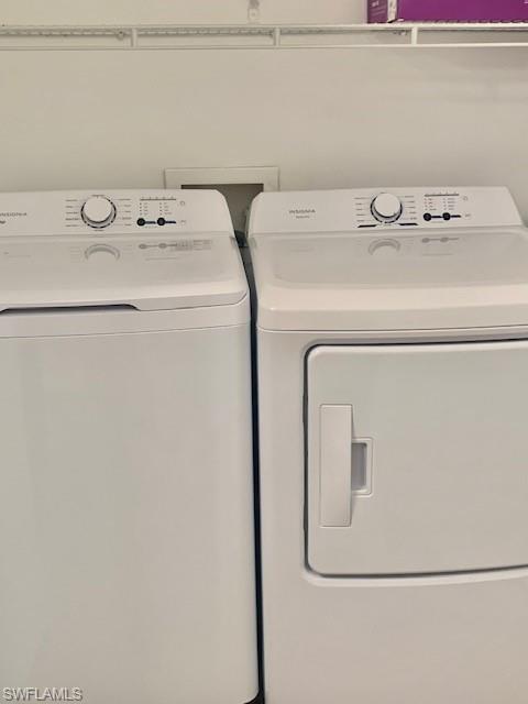 1210 Reserve Way, Unit 9203 Naples, FL 34105 - Photo 9 of 18 a utility room with dryer and washer