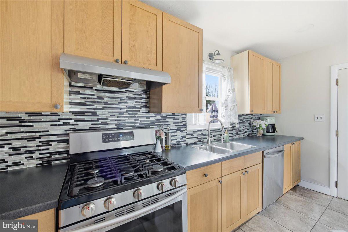 35 Rosedale Avenue Ewing, NJ 08638 - Photo 19 of 35 a kitchen with granite countertop a stove sink and cabinets