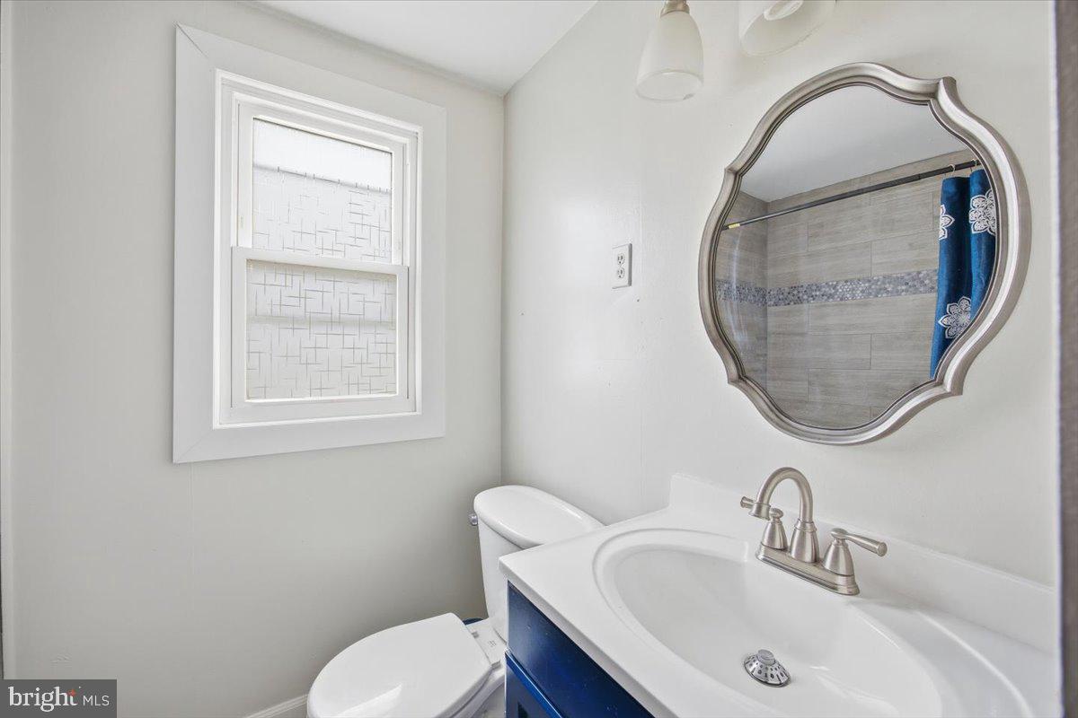 35 Rosedale Avenue Ewing, NJ 08638 - Photo 35 of 35 a bathroom with a sink mirror and toilet