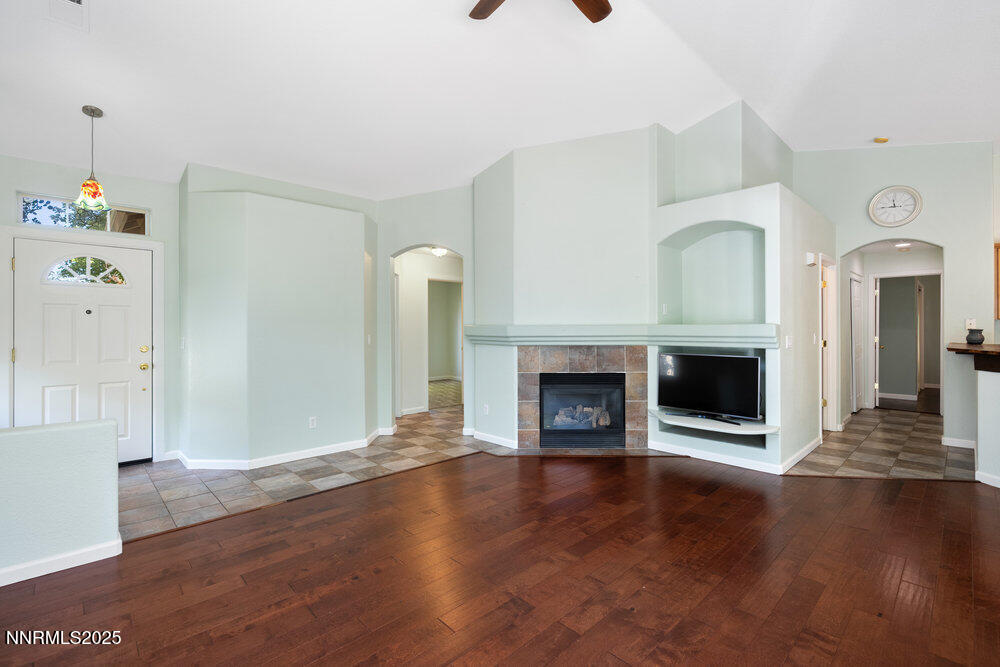 1706 River Gorge Court Reno, NV 89521 - Photo 14 of 40 a view of an empty room with wooden floor fireplace and a window