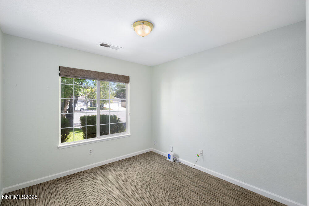 1706 River Gorge Court Reno, NV 89521 - Photo 20 of 40 a view of an empty room with a window and hardwood floor