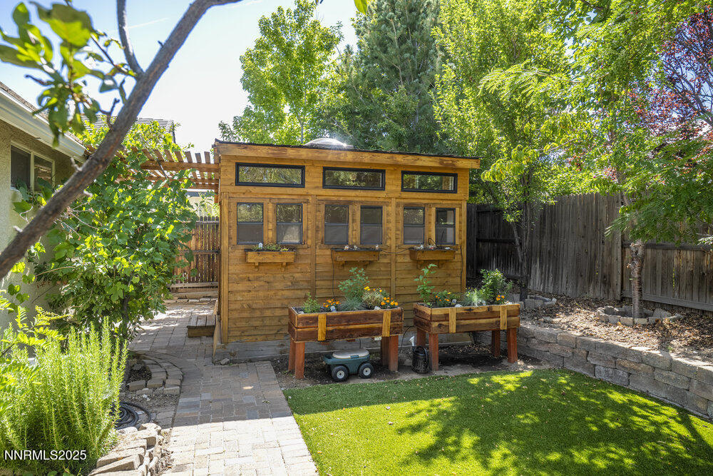 1706 River Gorge Court Reno, NV 89521 - Photo 24 of 40 a view of a house with backyard sitting area and garden