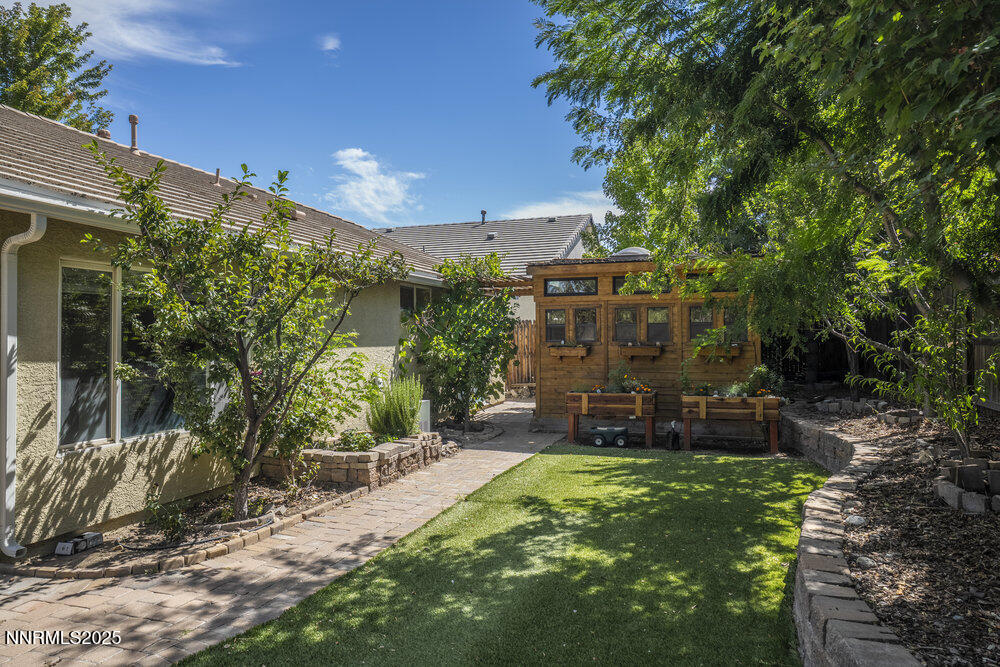 1706 River Gorge Court Reno, NV 89521 - Photo 30 of 40 a view of a patio with table and chairs potted plants and large tree
