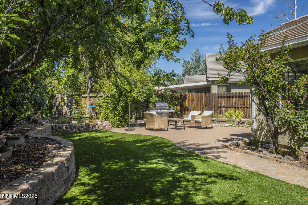 1706 River Gorge Court Reno, NV 89521 - Photo 31 of 40 a view of a chair and tables in the backyard of the house