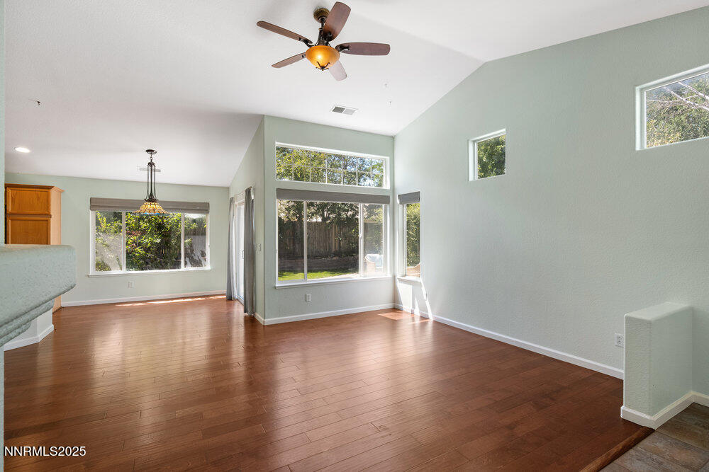 1706 River Gorge Court Reno, NV 89521 - Photo 5 of 40 a view of an empty room with a window and wooden floor