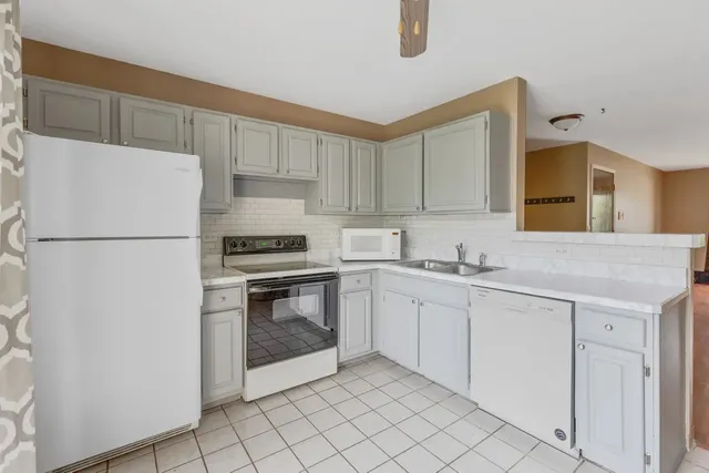 a kitchen with cabinets stainless steel appliances and a counter space