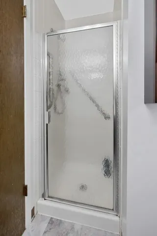a bathroom with a glass shower door