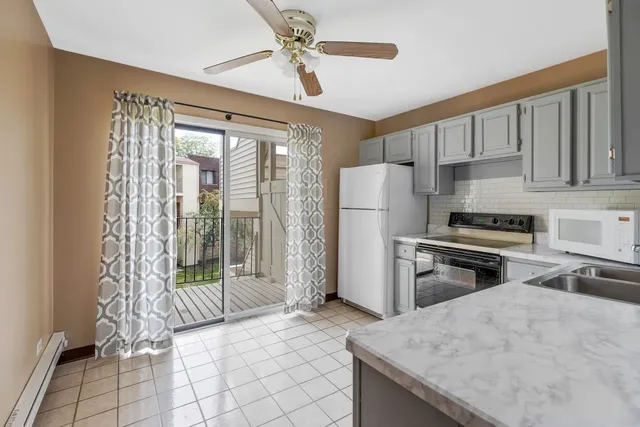 a kitchen with refrigerator and window