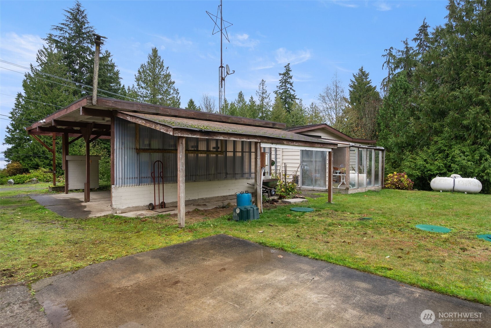 6091 Northeast Twin Spits Road Hansville, WA 98340 - Photo 20 of 34 a view of a house with backyard and porch