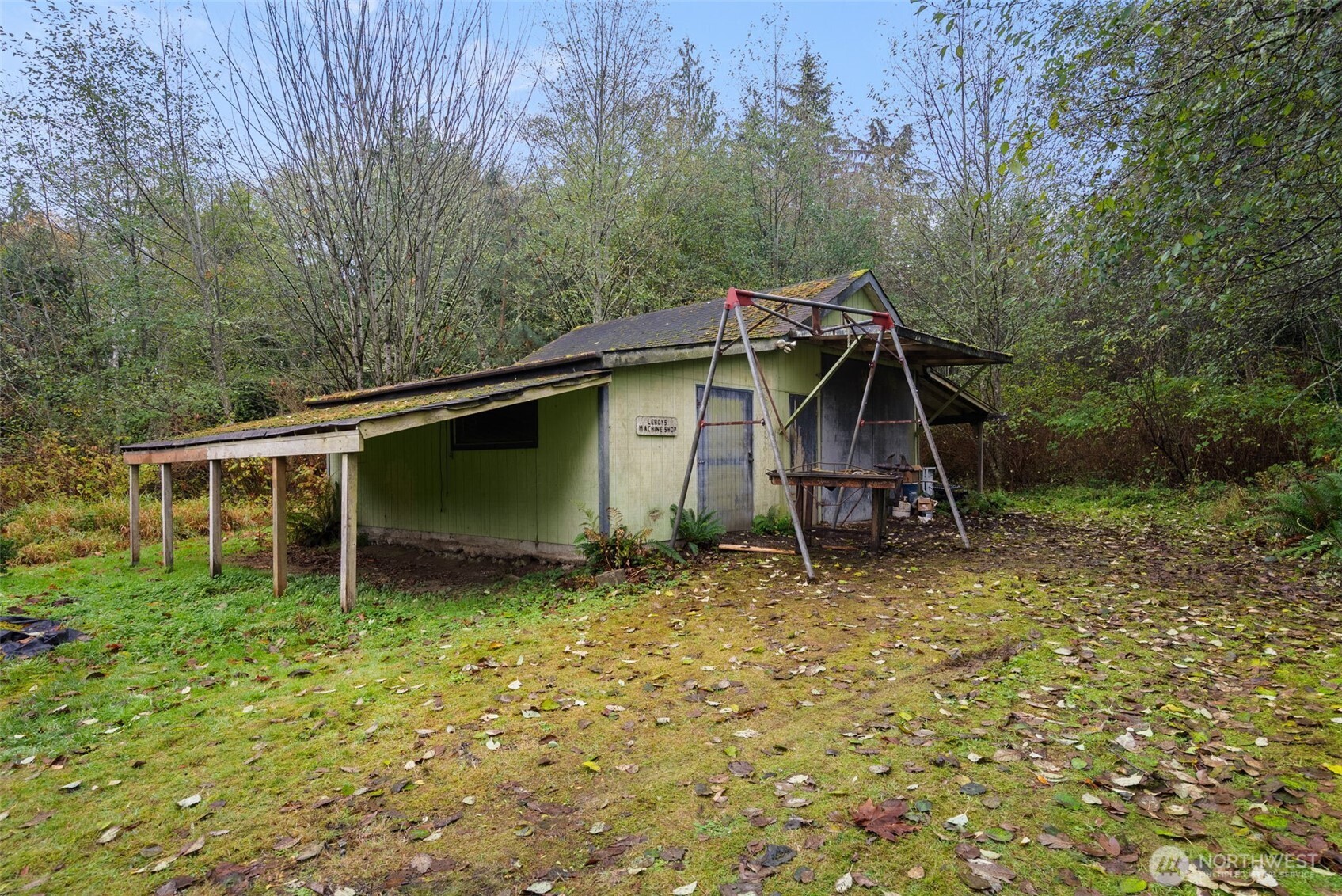 6091 Northeast Twin Spits Road Hansville, WA 98340 - Photo 28 of 34 a house with trees in the background