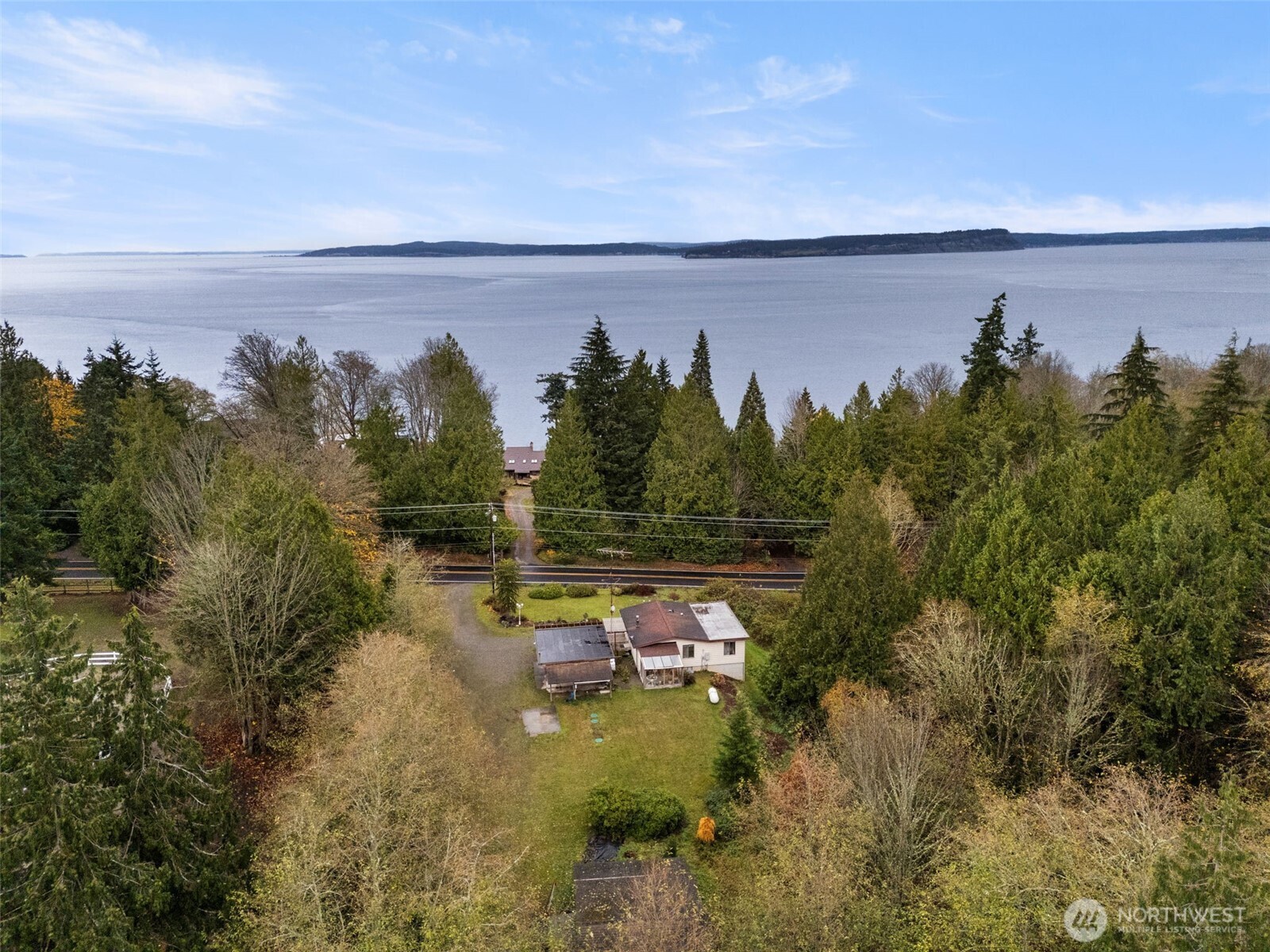 6091 Northeast Twin Spits Road Hansville, WA 98340 - Photo 32 of 34 a view of a yard in front of a house with a yard