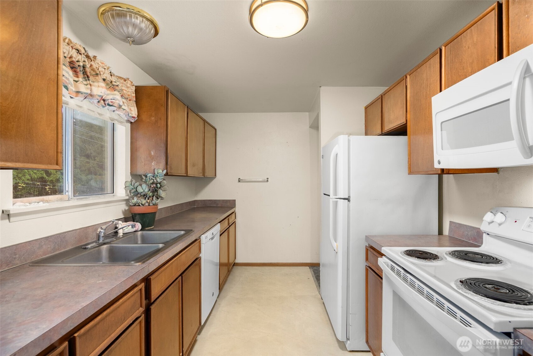 6091 Northeast Twin Spits Road Hansville, WA 98340 - Photo 7 of 34 a kitchen with a sink a stove and cabinets