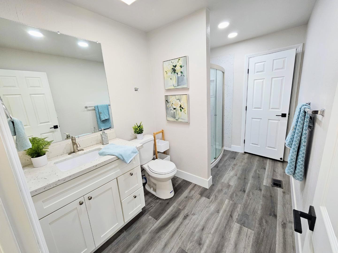 17675 Laurel Road Morgan Hill, CA 95037 - Photo 19 of 49 a spacious en suite bathroom with a granite countertop sink and a mirror