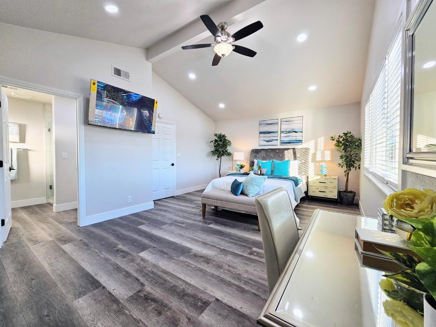 17675 Laurel Road Morgan Hill, CA 95037 - Photo 23 of 49 a bedroom with furniture and a chandelier