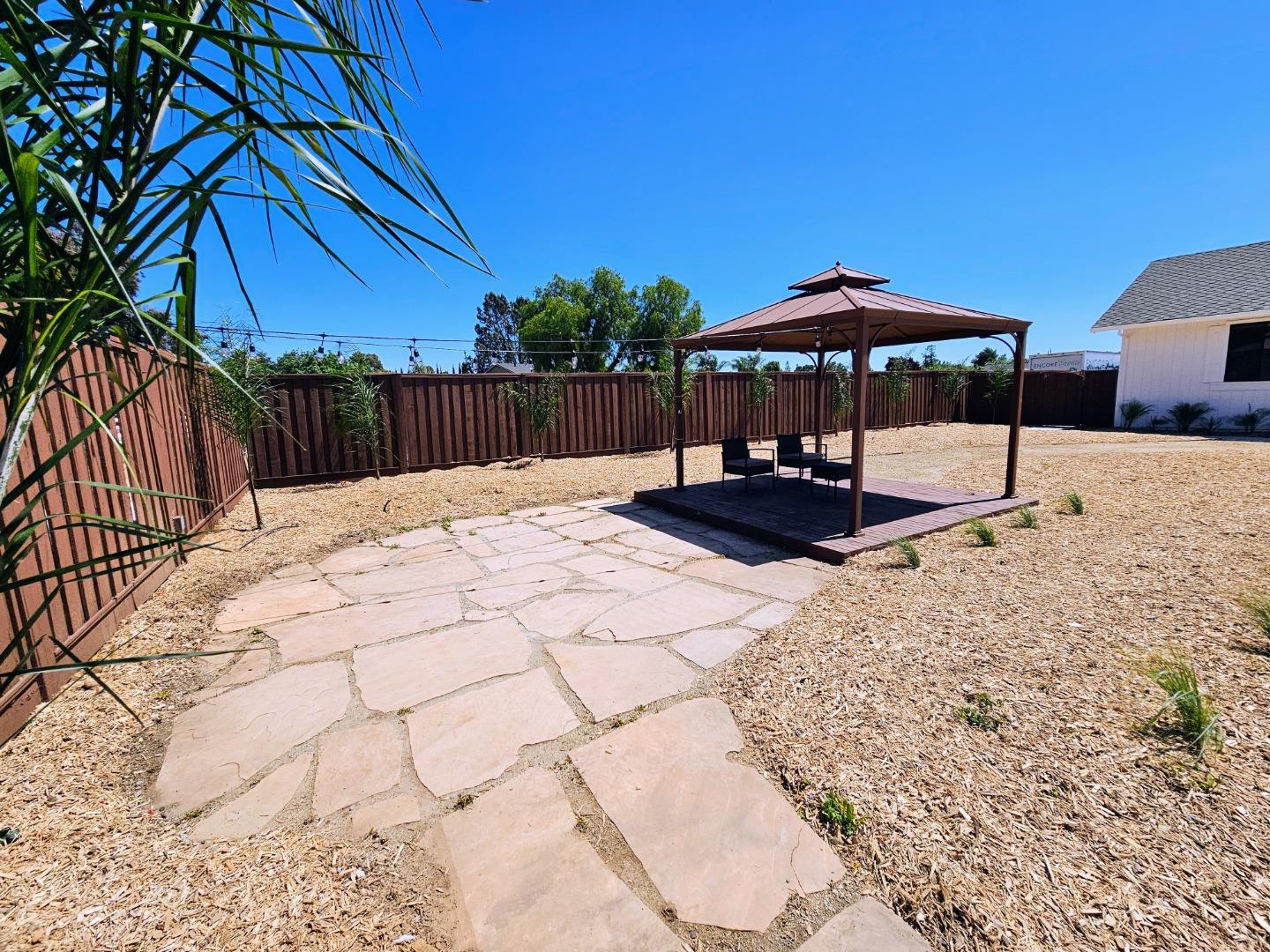 17675 Laurel Road Morgan Hill, CA 95037 - Photo 37 of 49 a white house with a yard and seating space