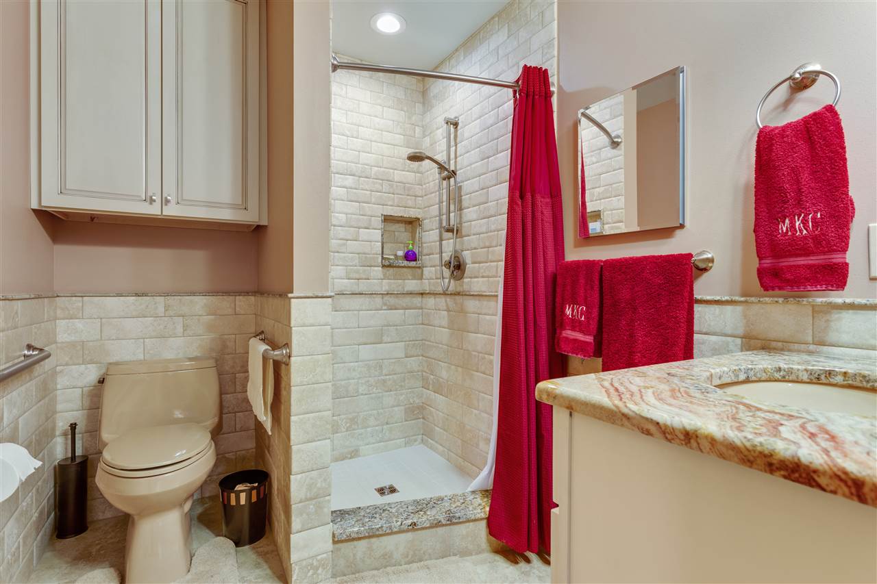 6871 Spring Brook Road Rockford, IL 61114 - Photo 11 of 24 a bathroom with a granite countertop sink a toilet and shower