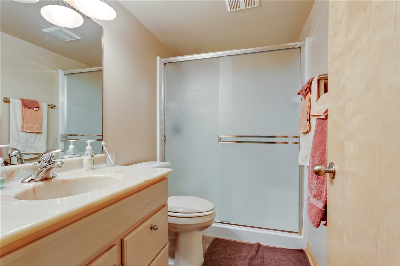 6871 Spring Brook Road Rockford, IL 61114 - Photo 18 of 24 a bathroom with a sink a toilet and shower