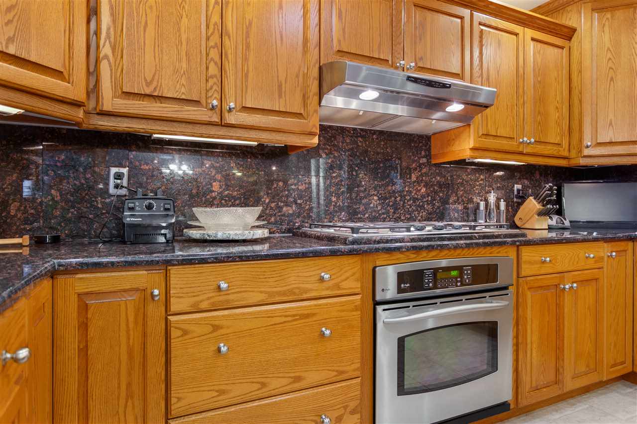 6871 Spring Brook Road Rockford, IL 61114 - Photo 2 of 24 a kitchen with granite countertop stainless steel appliances white cabinets sink and a granite counter top