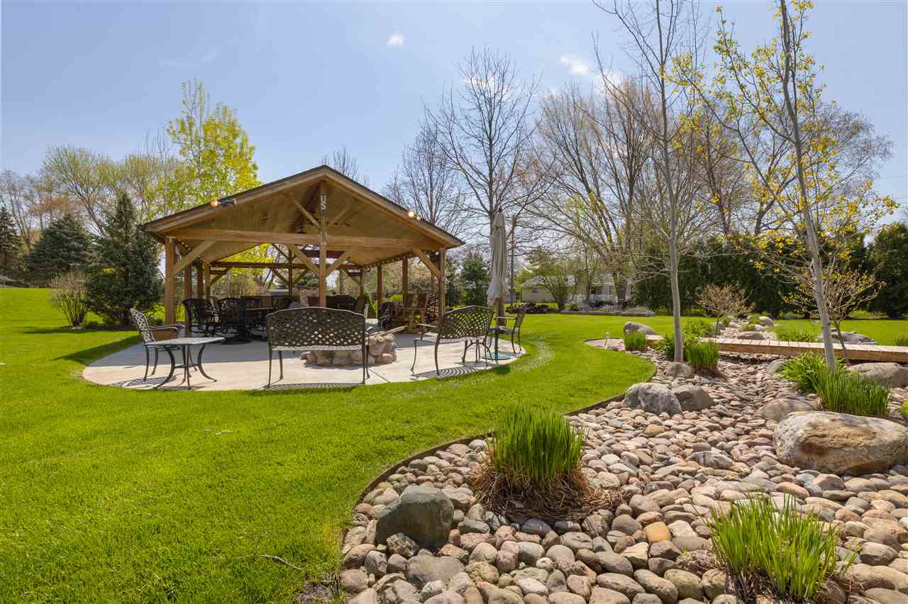 6871 Spring Brook Road Rockford, IL 61114 - Photo 23 of 24 a view of a house with a yard patio and swimming pool