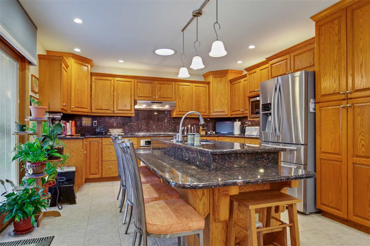6871 Spring Brook Road Rockford, IL 61114 - Photo 3 of 24 a kitchen with a refrigerator and a stove