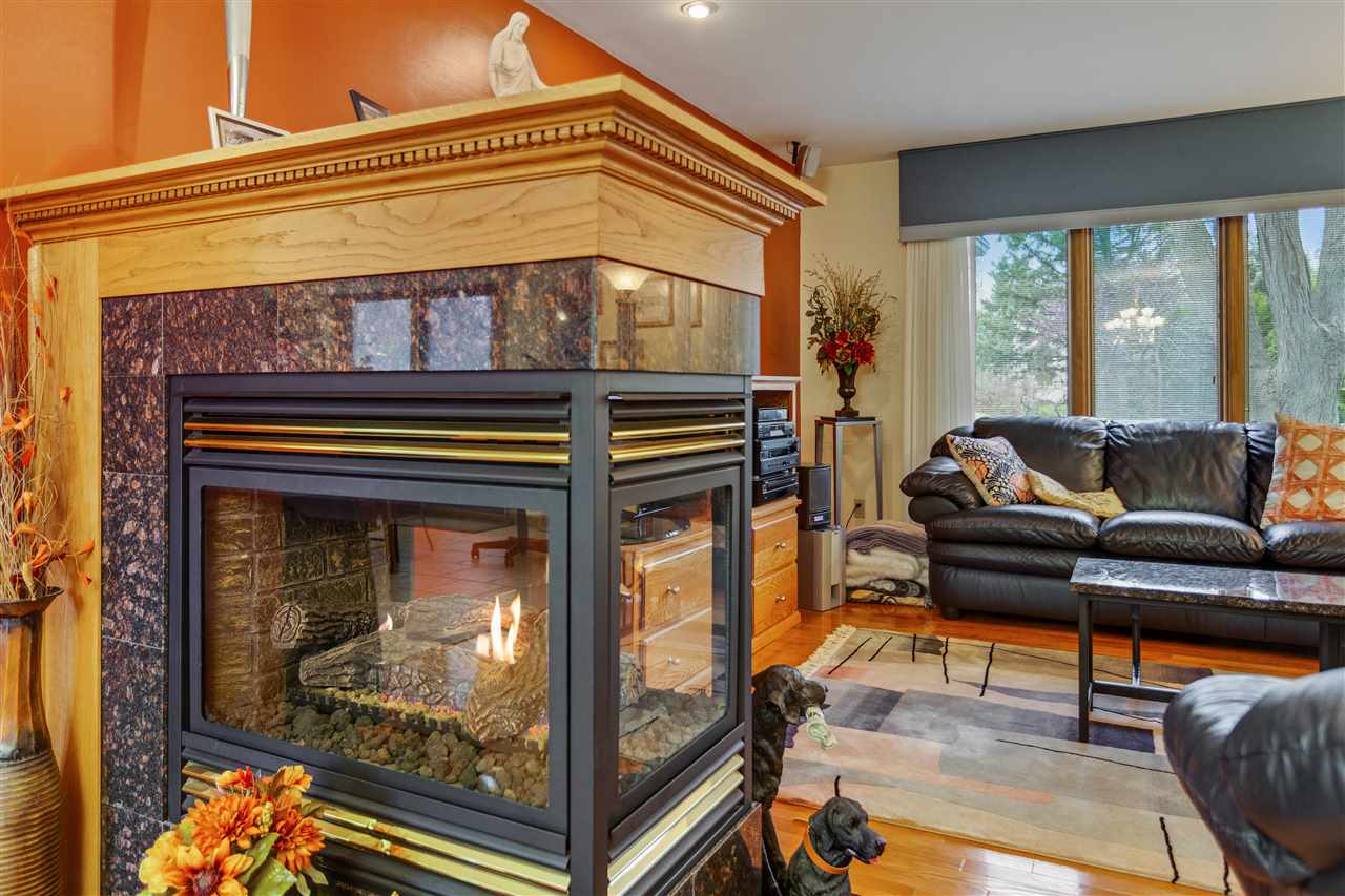 6871 Spring Brook Road Rockford, IL 61114 - Photo 5 of 24 a living room with furniture and a fireplace