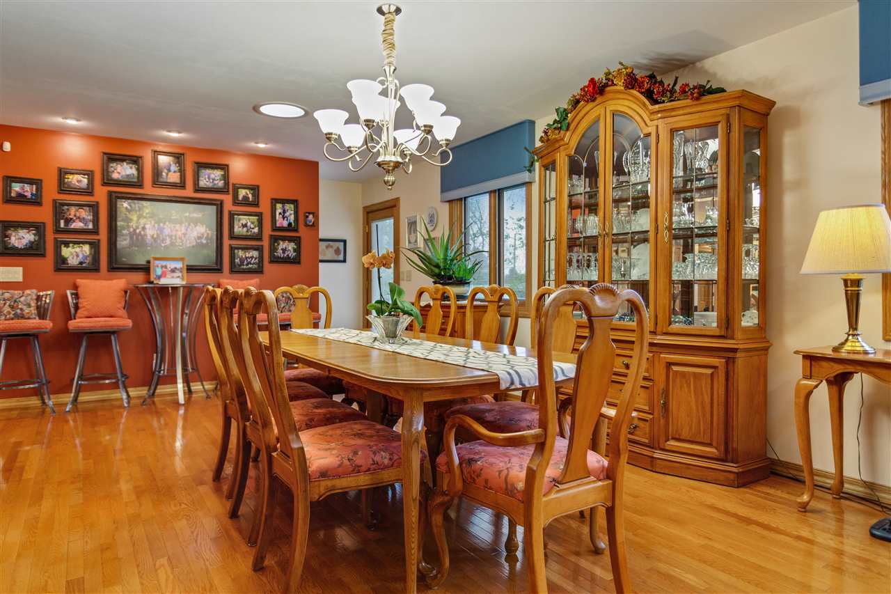6871 Spring Brook Road Rockford, IL 61114 - Photo 7 of 24 a view of a dining room with furniture and chandelier