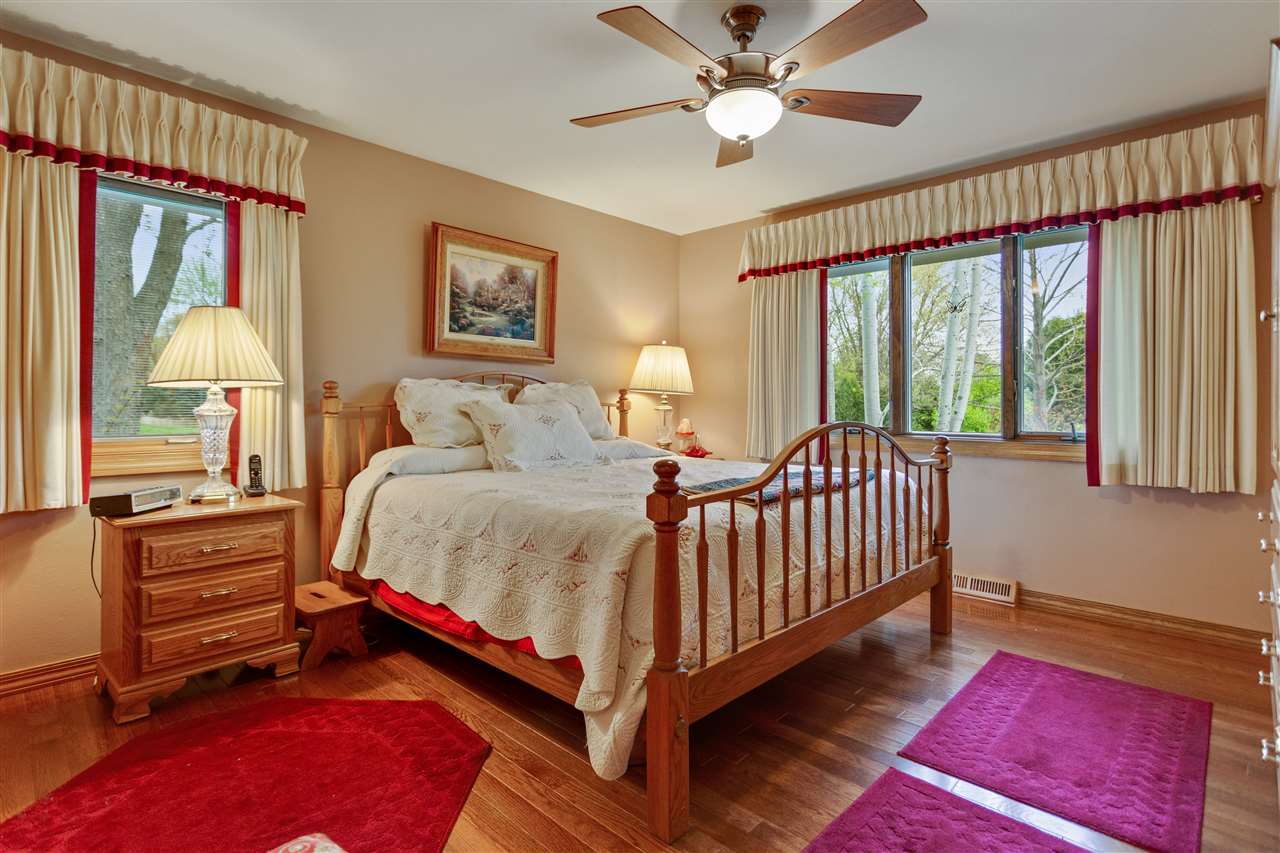 6871 Spring Brook Road Rockford, IL 61114 - Photo 10 of 24 a bed room with a bed and a lamp