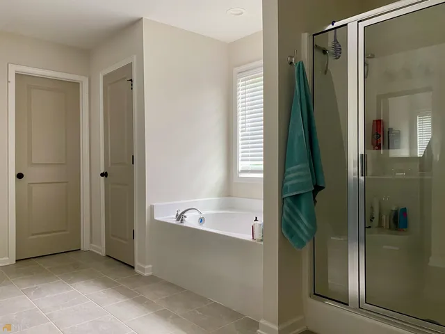 a bathroom with a tub and a shower