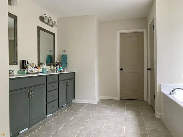 a bathroom with a sink a toilet and mirror