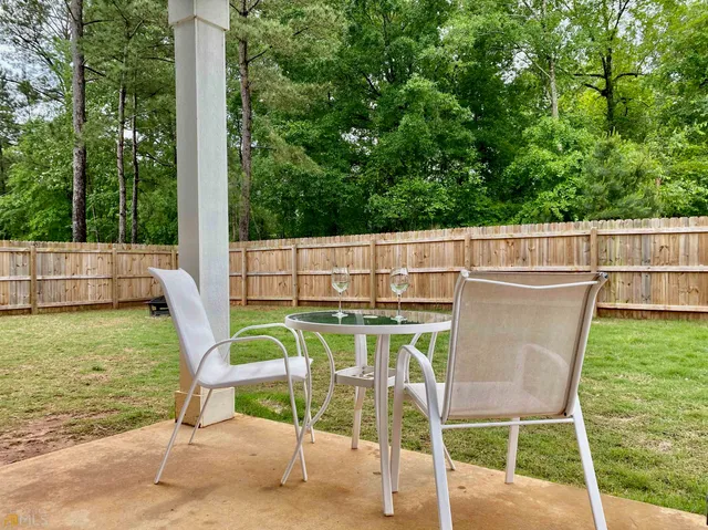 a view of a chairs and table in the patio