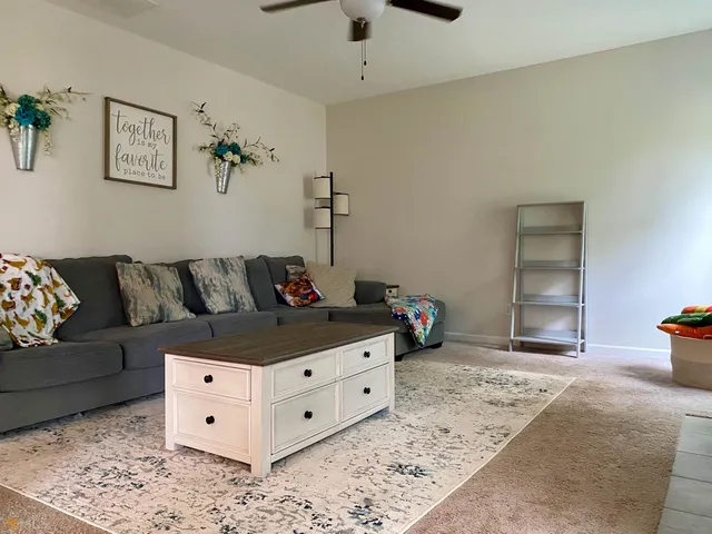 a living room with furniture and a rug