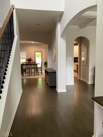 a view of a livingroom with furniture hardwood floor and a kitchen