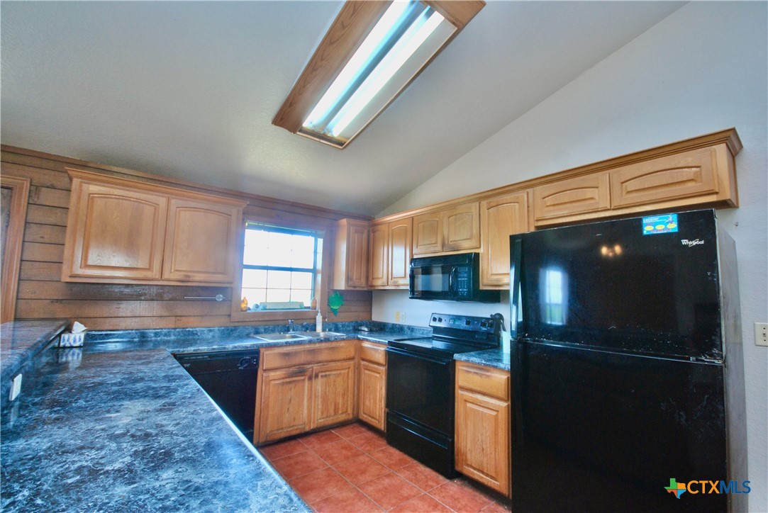 2725 Old Lehmann Road Seguin, TX 78155 - Photo 12 of 47 a kitchen with stainless steel appliances granite countertop a refrigerator a sink dishwasher a stove and white cabinets with wooden floor